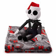 Load image into Gallery viewer, Jack Skellington plush doll wearing Santa hat, sitting on folded Nightmare Before Christmas throw blanket featuring festive spooky motifs.