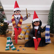 Load image into Gallery viewer, Two Scout Elves in Hogwarts sweater, robe and house scarves on a sofa with a Christmas tree

