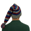 Load image into Gallery viewer, Back view of long striped stocking cap with ribbed cuff and tassel resting on shoulder
