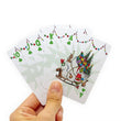 Load image into Gallery viewer, Hand holding fanned Dr. Seuss Grinch playing cards showing 10 through ace of clubs
