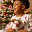 Load image into Gallery viewer, Smiling child hugging an Elf Pets Saint Bernard plush at Christmas
