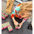 Load image into Gallery viewer, Patty Johnson, who played the Head Elf in A Christmas Story, personally signing Department 56 Department Store Elves figurine boxes at a signing event
