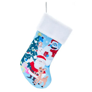 Christmas stocking featuring Rudolph, Santa Claus, Bumble the Abominable Snow Monster, and Hermey the elf with a Christmas tree and presents. White plush cuff.